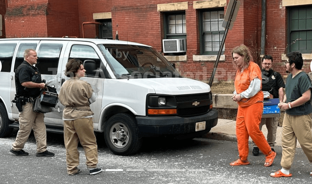 Deputies escort Michelle Zajko, left, Daniel Blank, right, and Jack LaSota, in orange, from the Allegany County Courthouse after a pretrial hearing in Cumberland, Maryland, on January 16, 2026. 