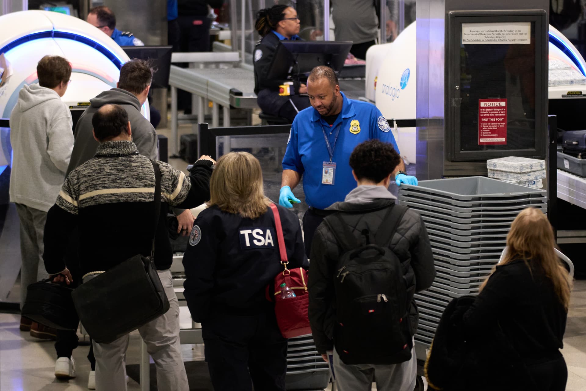 Travelers wait at a TSA security checkpoint at Detroit, Michigan, on November 30, 2025.