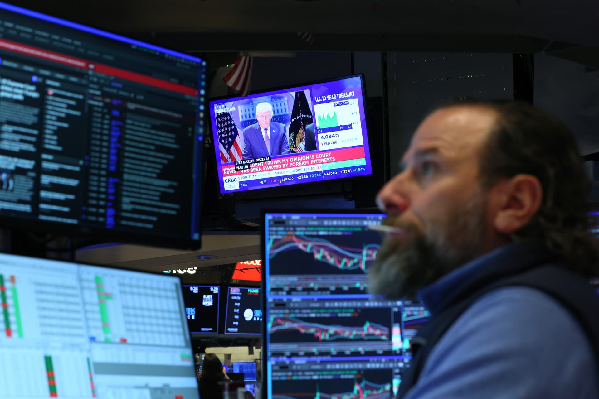 A trader on the New York Stock Exchange monitors a television as President Trump responds to  the Supreme Court ruling on his ‘Liberation Day’ tariffs on February 20, 2026.