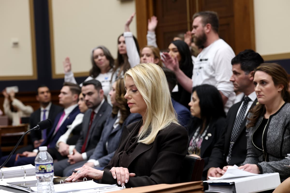 Survivors of convicted sex offender Jeffrey Epstein stand in the audience as U.S. Attorney General Pam Bondi testifies before the House Judiciary Committee on February 11, 2026, at Washington, DC. 