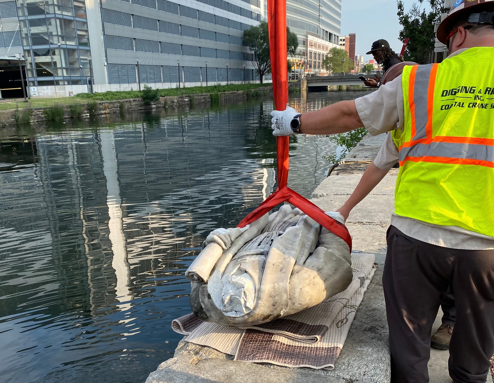 A statue of Christopher Columbus is pulled out of the Inner Harbor in Baltimore, July 6, 2020, after protesters had thrown the statue into the harbor.
