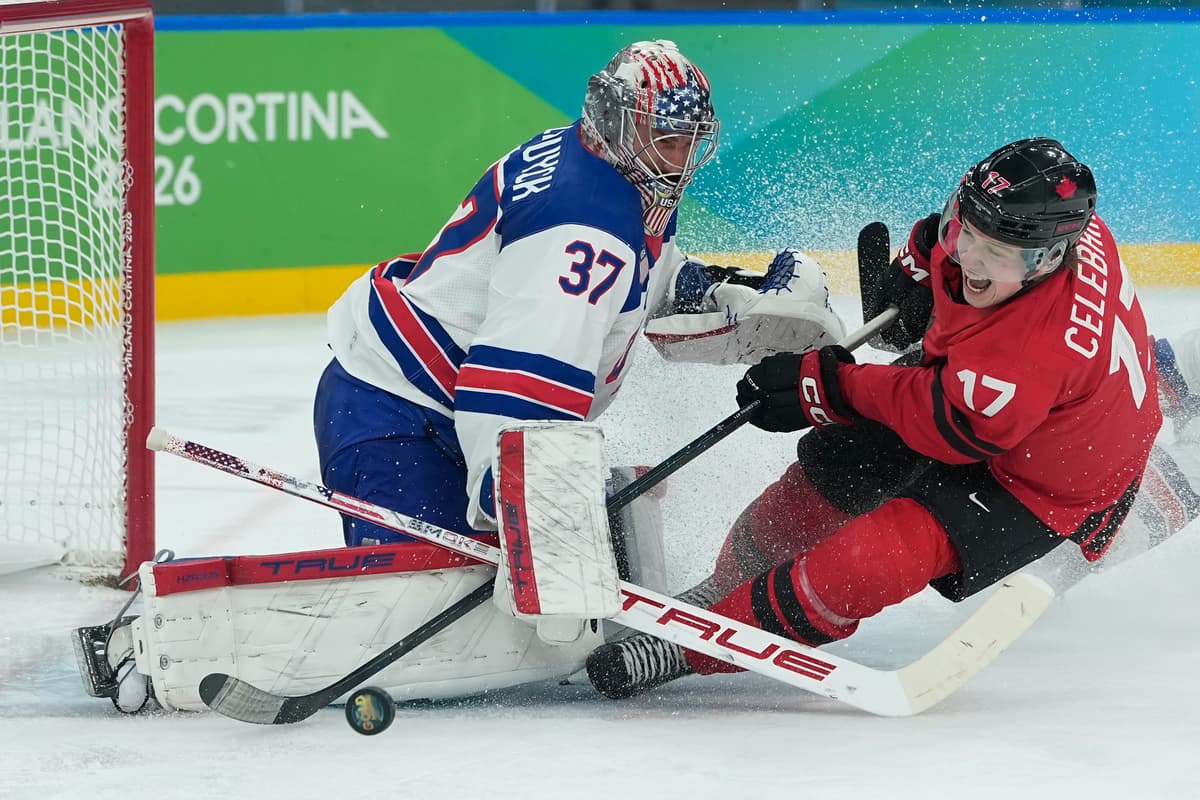 United States' Connor Hellebuyck (37) stops a shot attempt by Canada's Macklin Celebrini (17) during the third period of a men's ice hockey gold medal game between Canada and the United States.