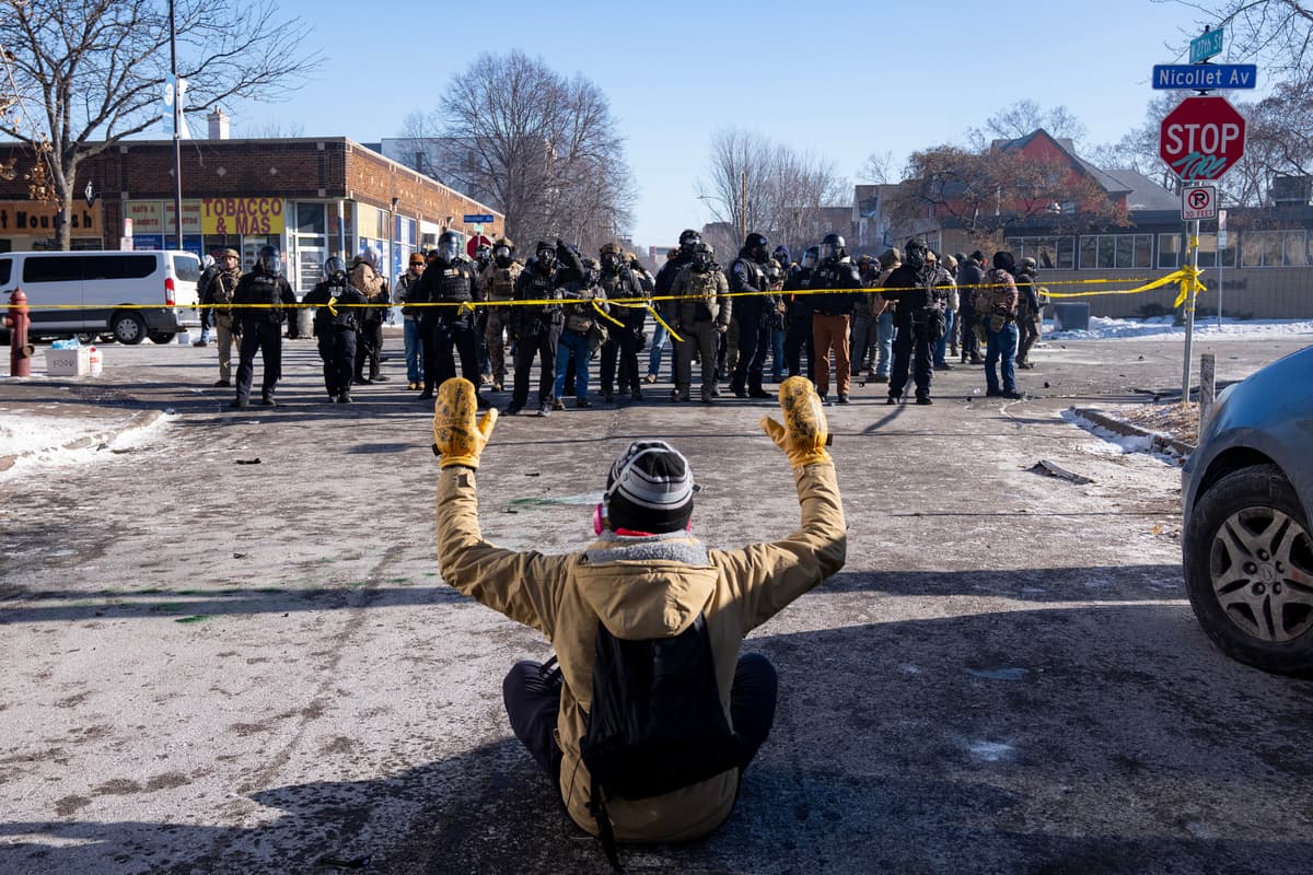 A protester in front of federal agents at Minneapolis, January 24, 2026.