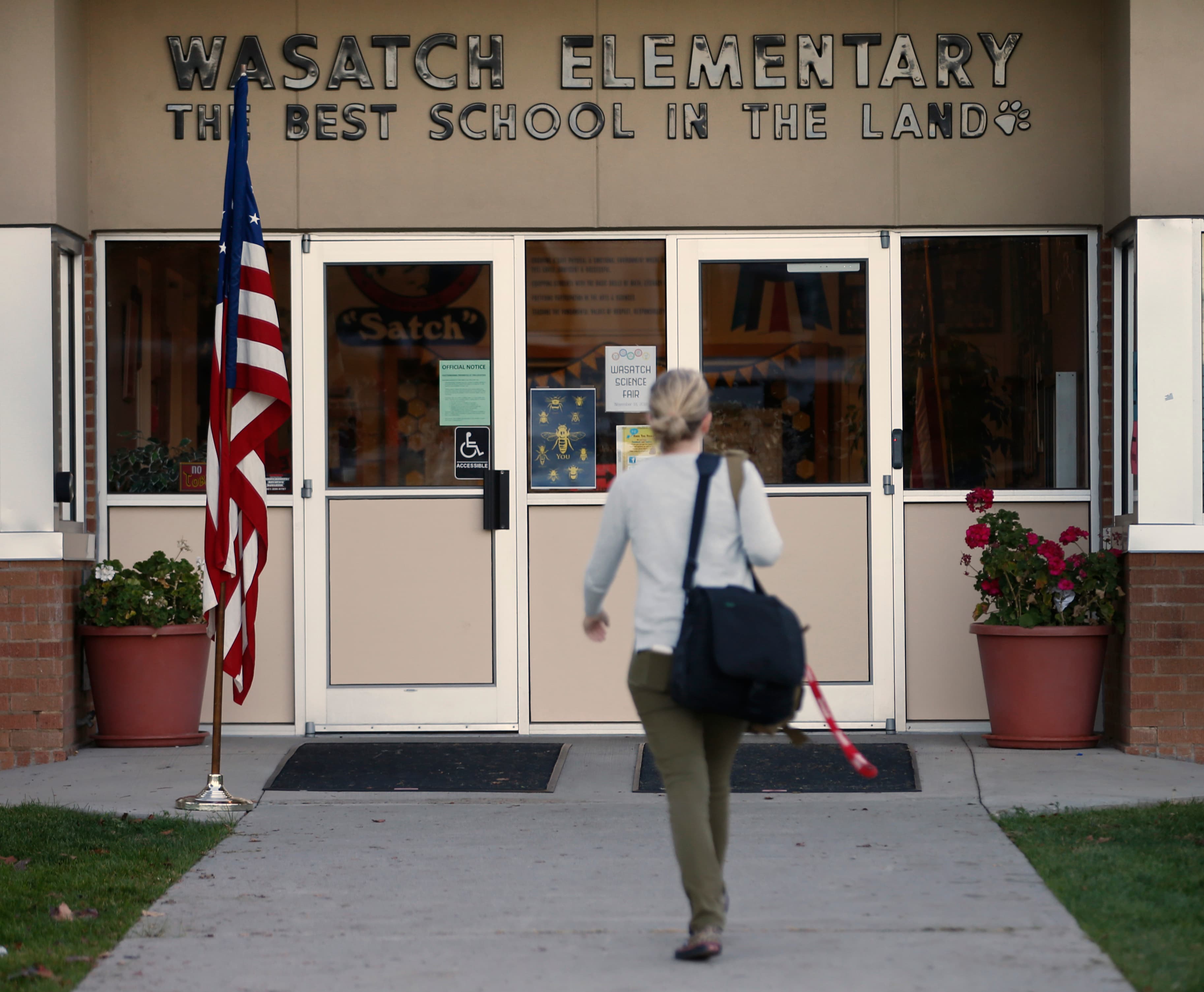 A woman enters Wasatch Elementary school in Utah.