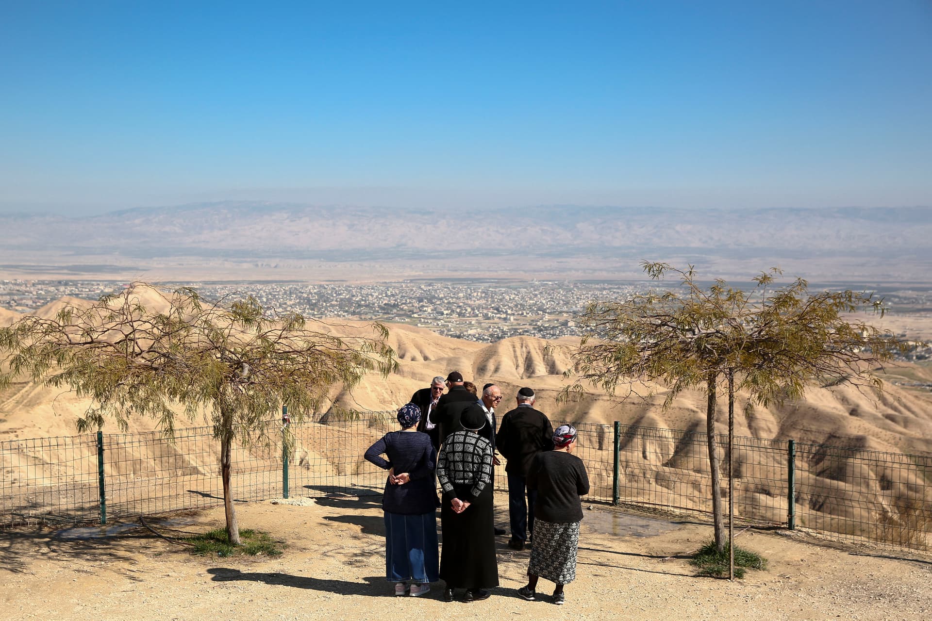 Jewish settlers stand at a view point overlooking the West Bank city of Jericho from the Jewish settlement of Mitzpe Yeriho. 