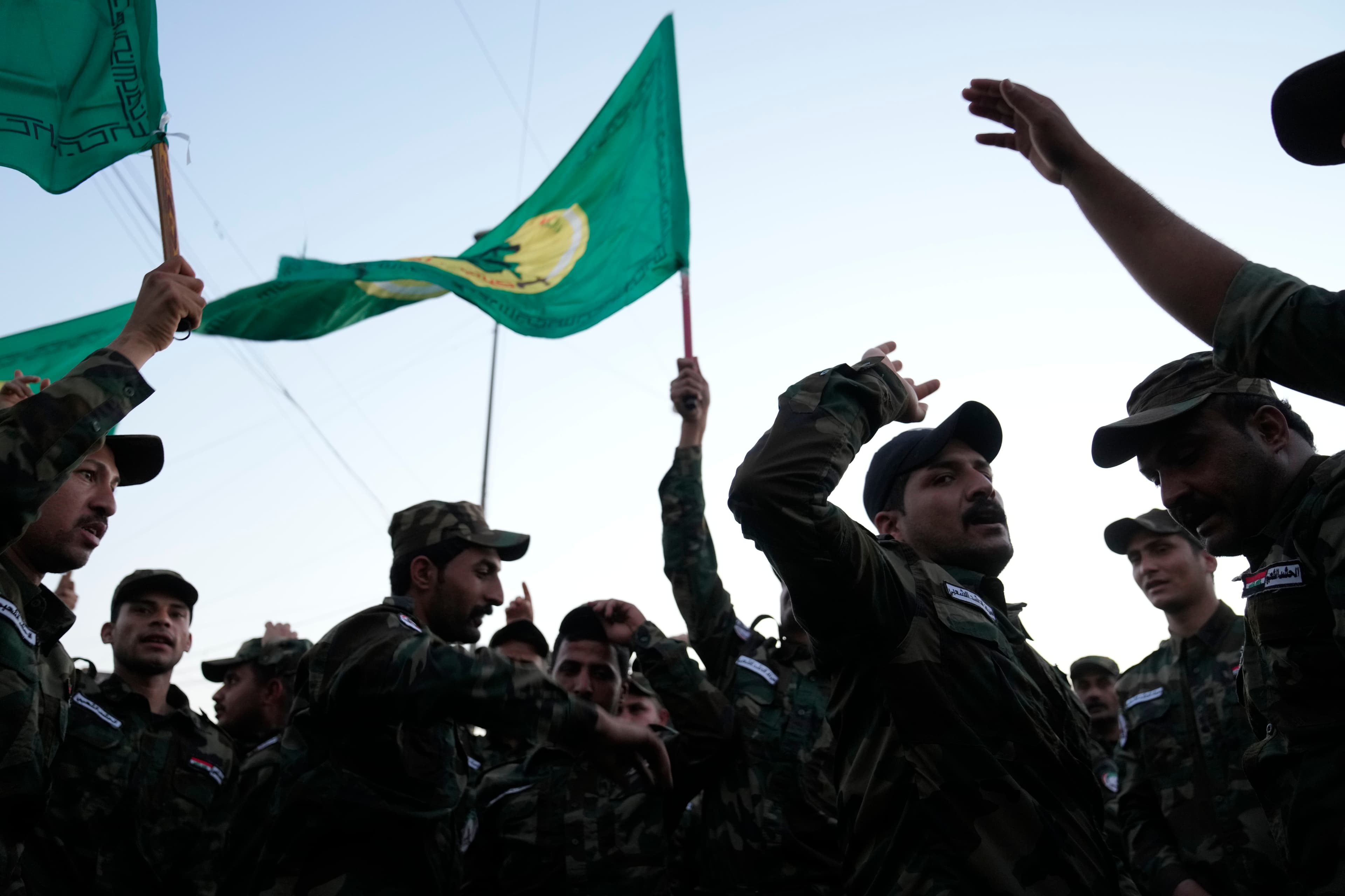 Members of an Iraqi Shiite militant group attend the funeral of an fighter who was killed in a U.S. airstrike Province, in Baghdad, Iraq, Thursday, Jan. 4, 2024.  