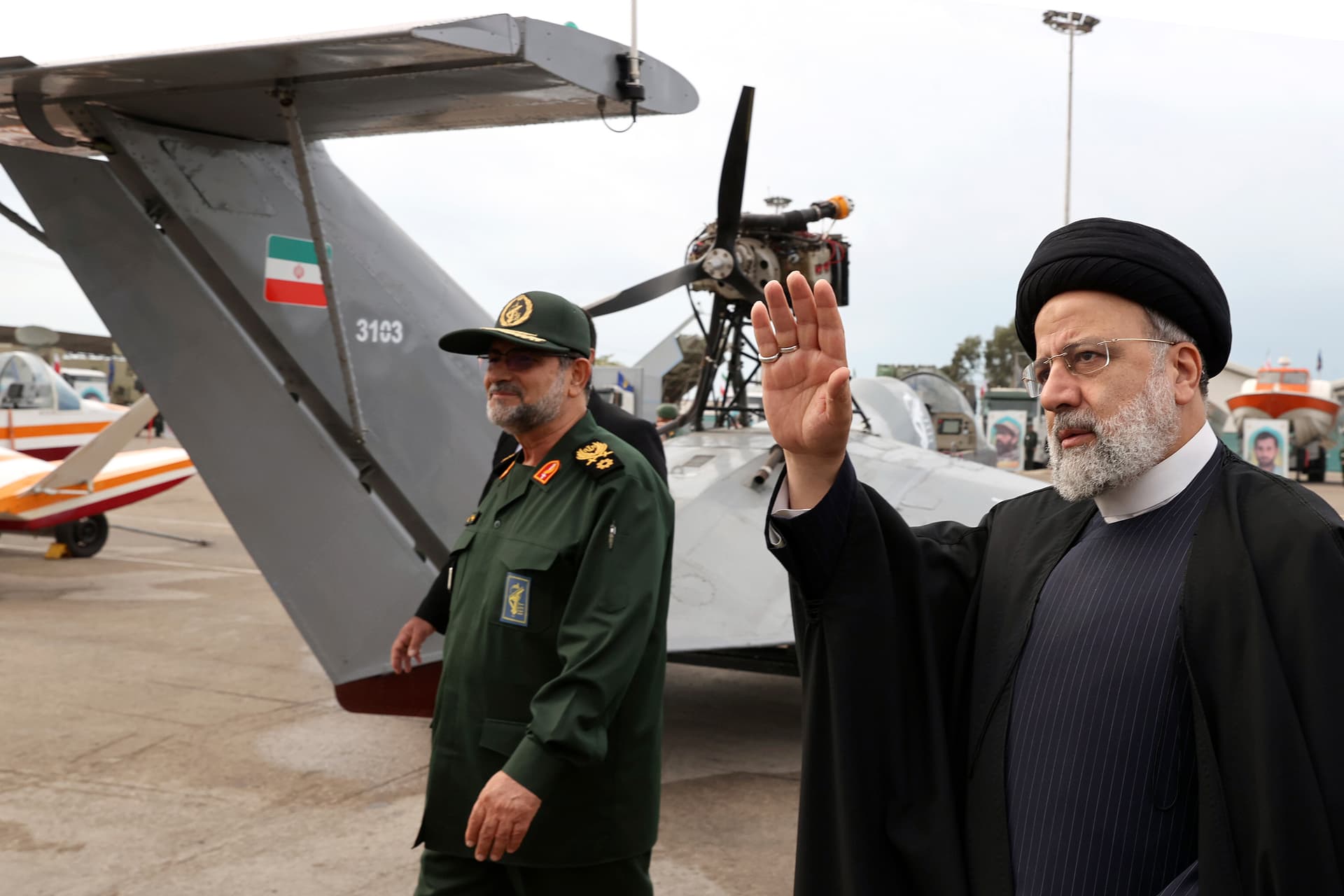 In this photo released by the Iranian Presidency Office, President Ebrahim Raisi waves as he visits an exhibition of the Revolutionary Guard navy capabilities while accompanied by the guard's navy commander Alireza Tangsiri, in the southern port city of Bandar Abbas, Iran, February 2, 2024. 