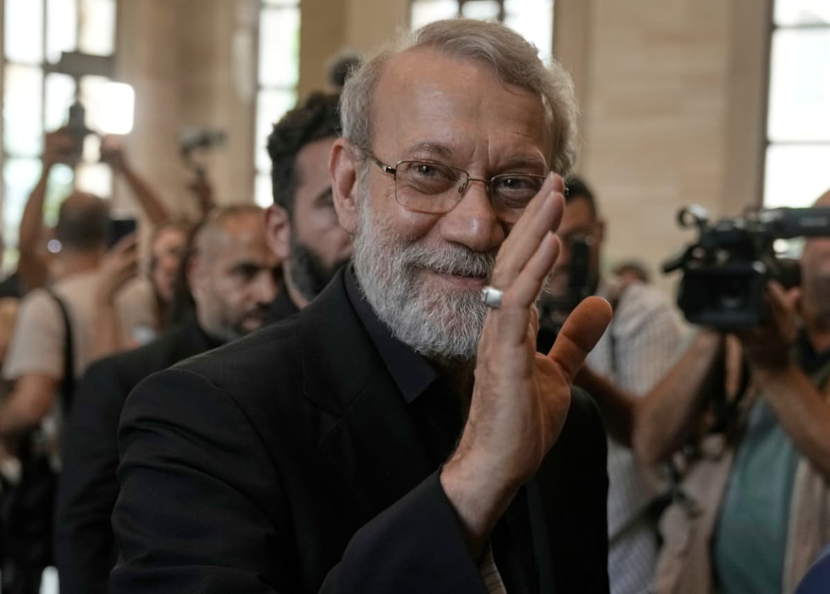 Ali Larijani greets journalists upon his arrival to meet with the Lebanese parliament speaker at Beirut, Lebanon, on August 13, 2025.