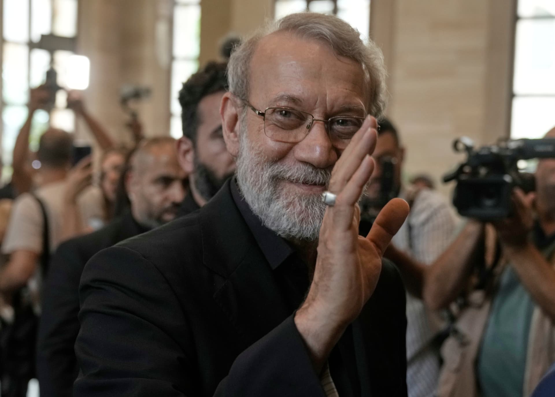 Ali Larijani greets journalists upon his arrival to meet with the Lebanese parliament speaker at Beirut, Lebanon, on August 13, 2025.