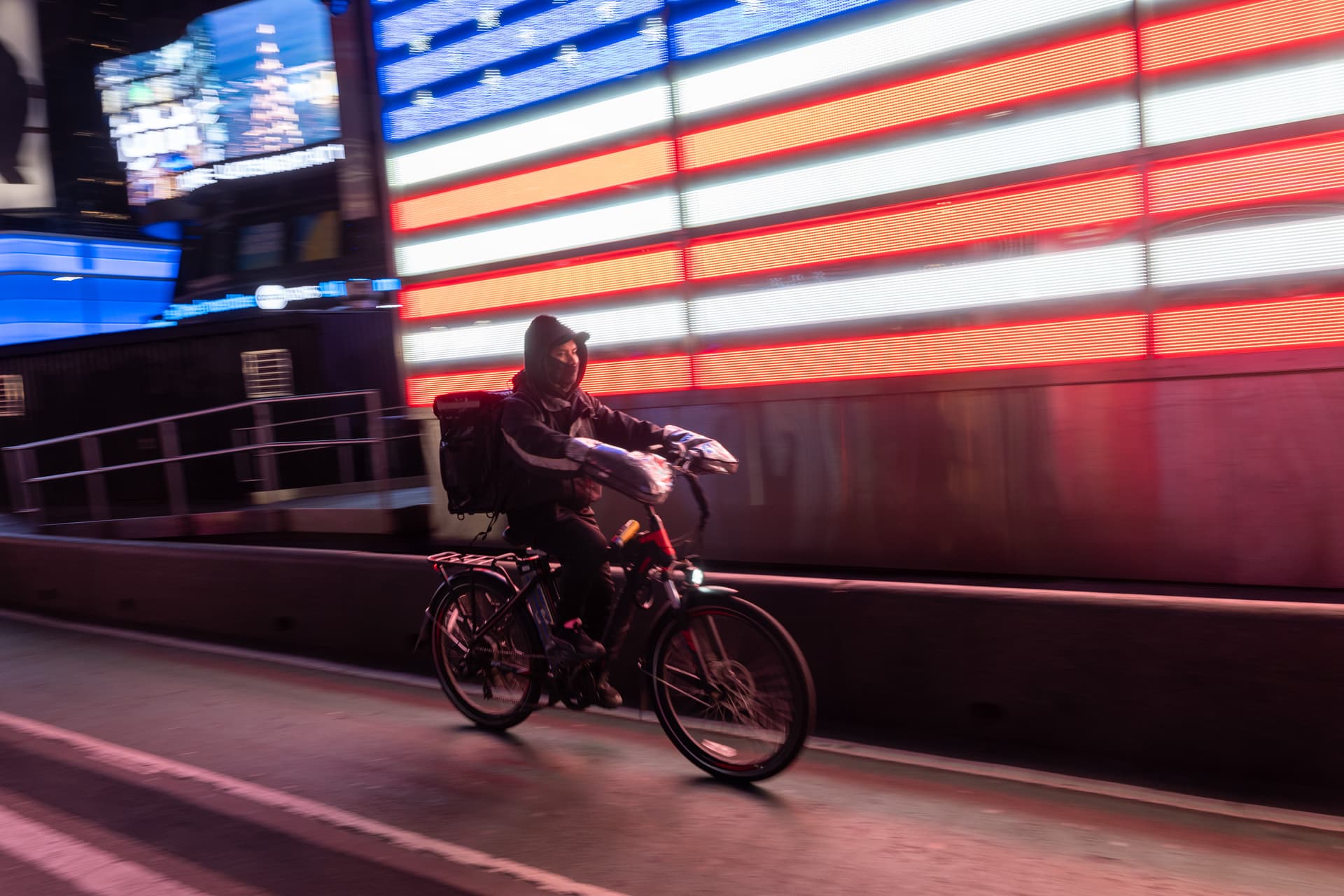 A food delivery worker uses an electric bicycle at New York City's Times Square.  