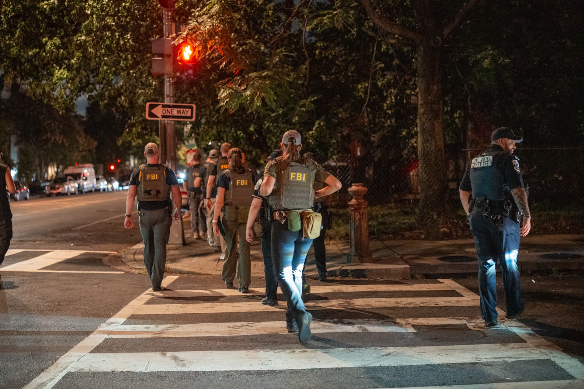 FBI agents walk on patrol in the U street neighborhood on August 13, 2025 in Washington, DC. President Trump announced plans to deploy federal officers and the National Guard to the District in order to place the DC Metropolitan Police Department under federal control and assist in crime prevention in the nation's capital.  