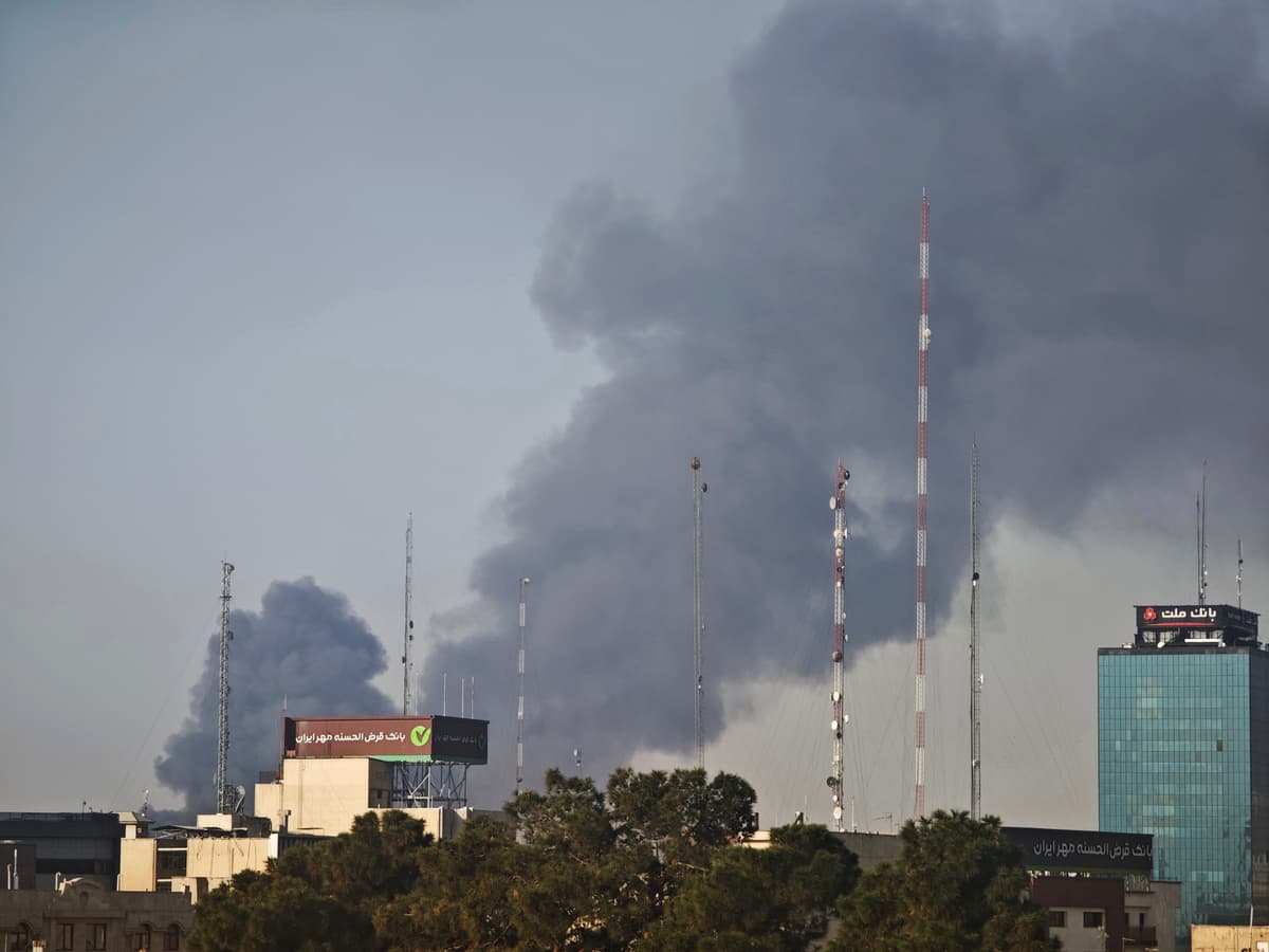 Smoke rises over buildings following explosions on March 6, 2026 at Tehran, Iran. 