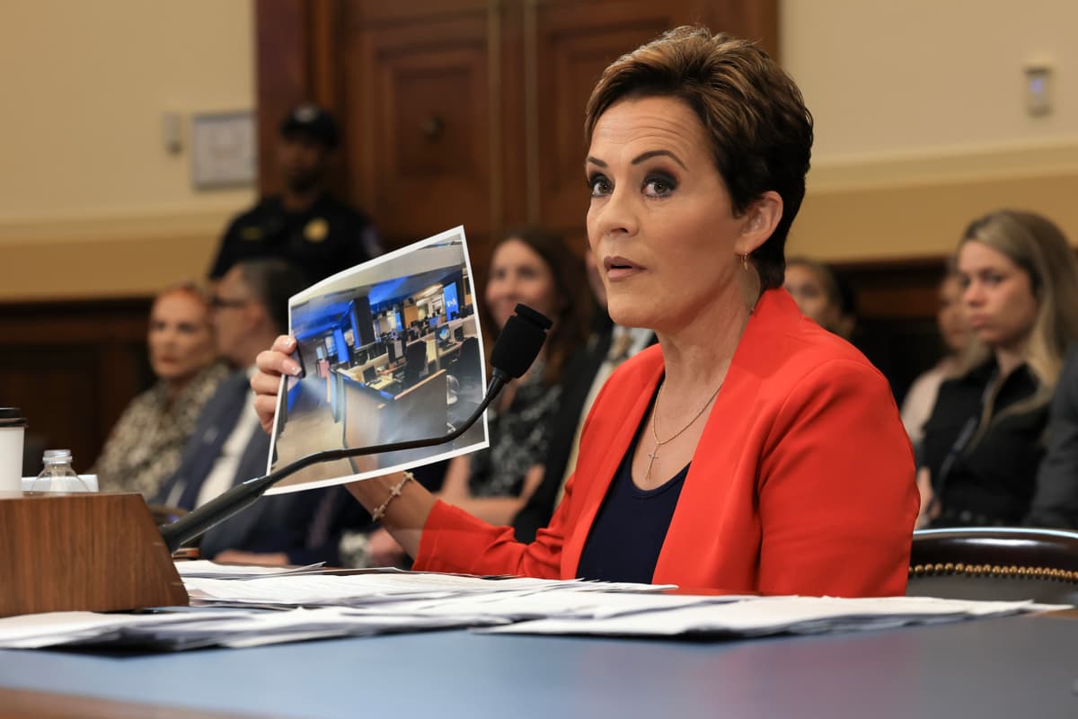 Kari Lake displays a photograph of an empty Voice of America newsroom during testimony to a House Committee on Foreign Affairs hearing at Washington, D.C., on June 25, 2025 