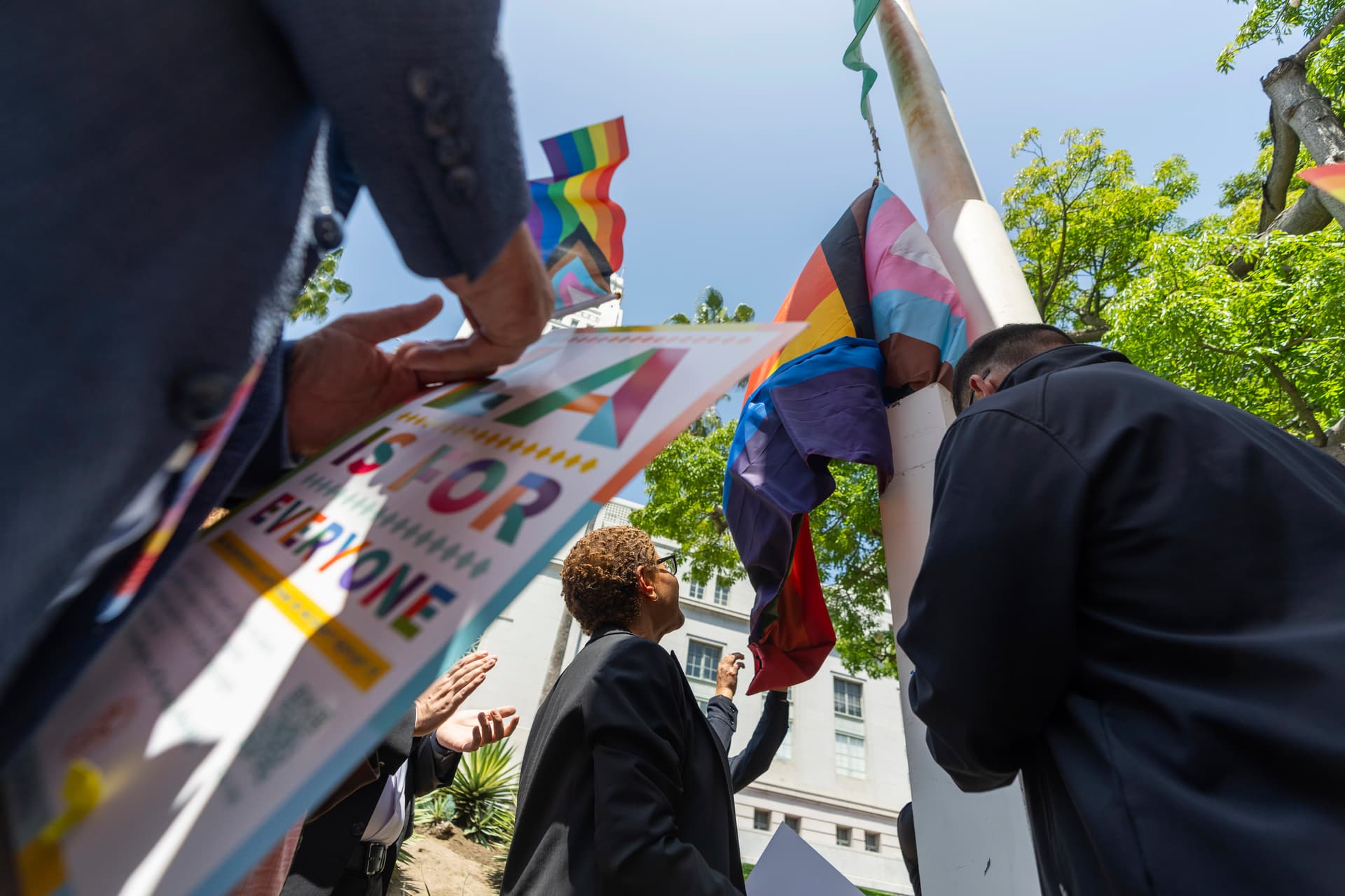 Los Angeles Mayor Karen Bass, center, joins a ceremony flying the LGBTQ+ Pride Flag during the month of Pride outside Los Angeles City Hall, June 6, 2024. 