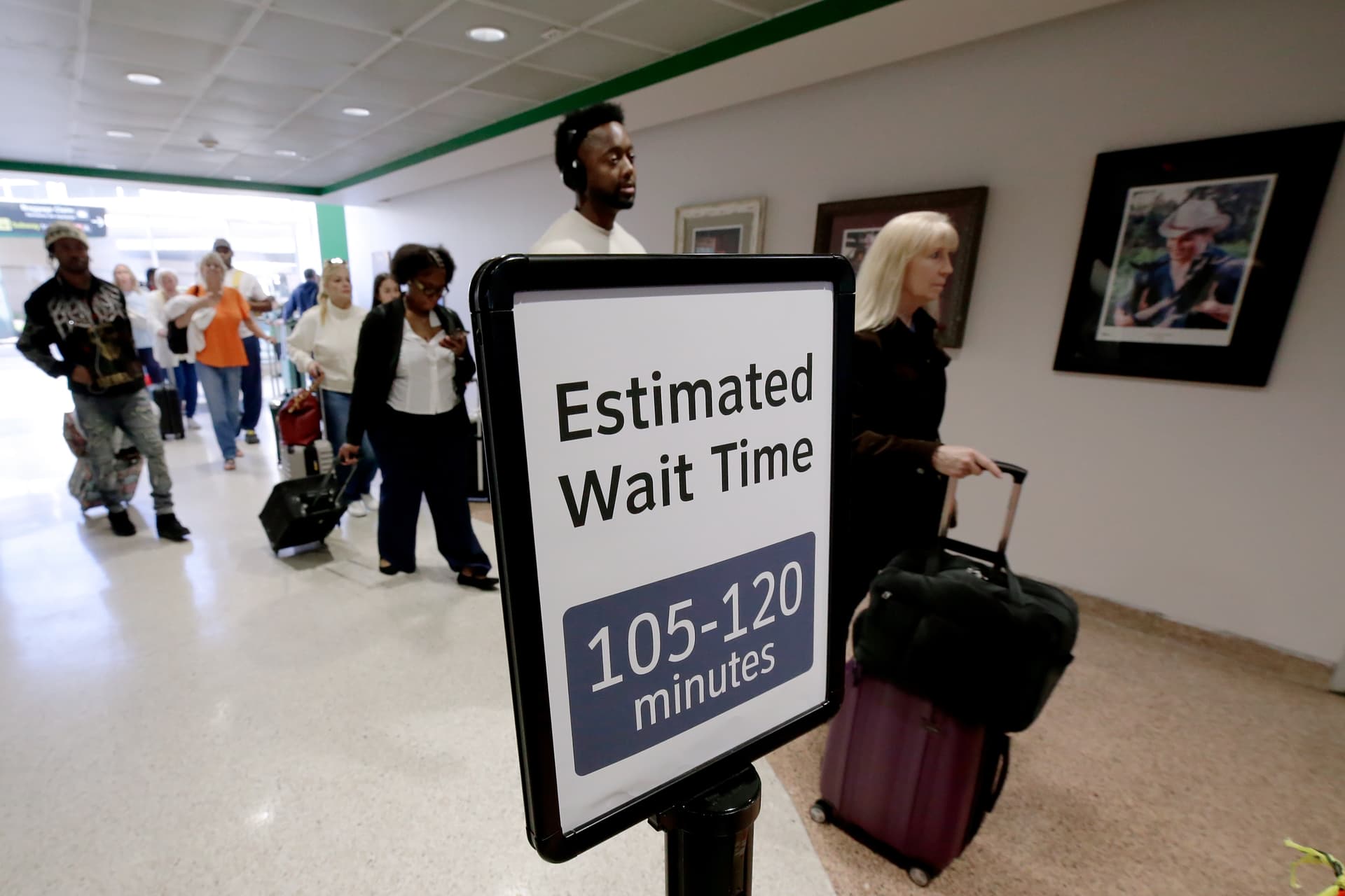 Air travelers wait in line as they progress to the TSA security checkpoint in Terminal A at the George Bush Intercontinental Airport, Monday, March 23, 2026, in Houston.