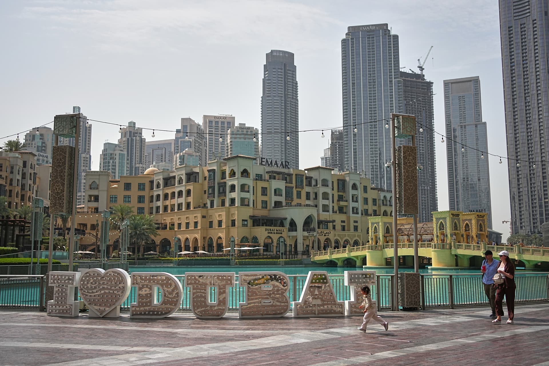 People walk in a public plaza in downtown Dubai Tuesday, March 3, 2026.
