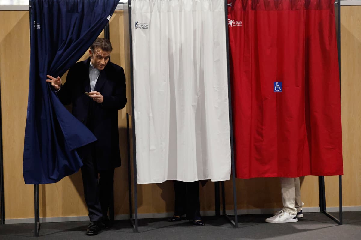 President Emmanuel Macron leaves the voting booth during the first round of France's municipal elections, March 15, 2026.