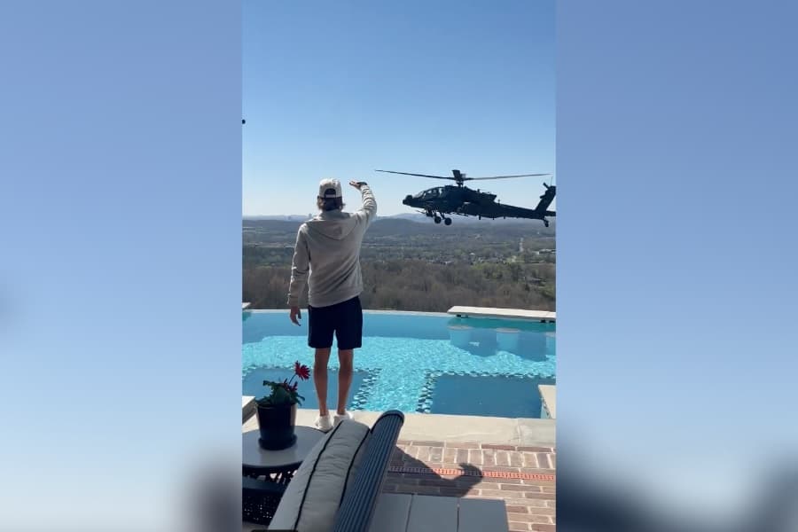 Singer Kid Rock salutes an Army helicopter hovering over his Nashville home Saturday.