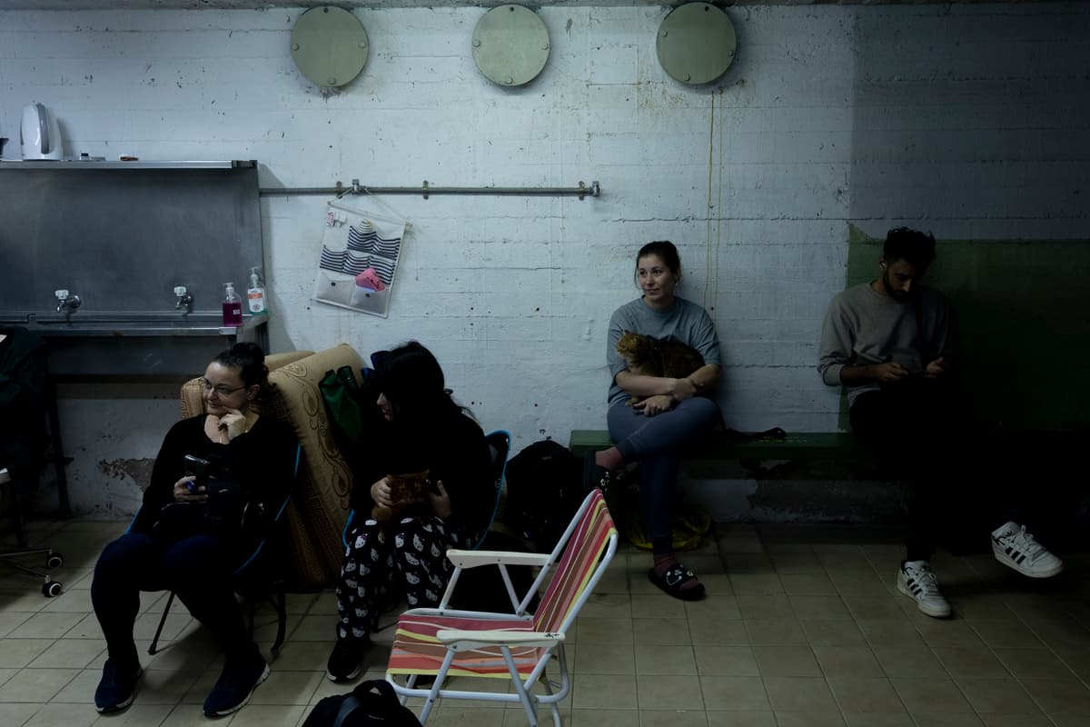 People take a cover in a bomb shelter as a siren warning goes off for incoming ballistic missiles from Iran on March 18, 2026 at Ramat Gan, Israel.