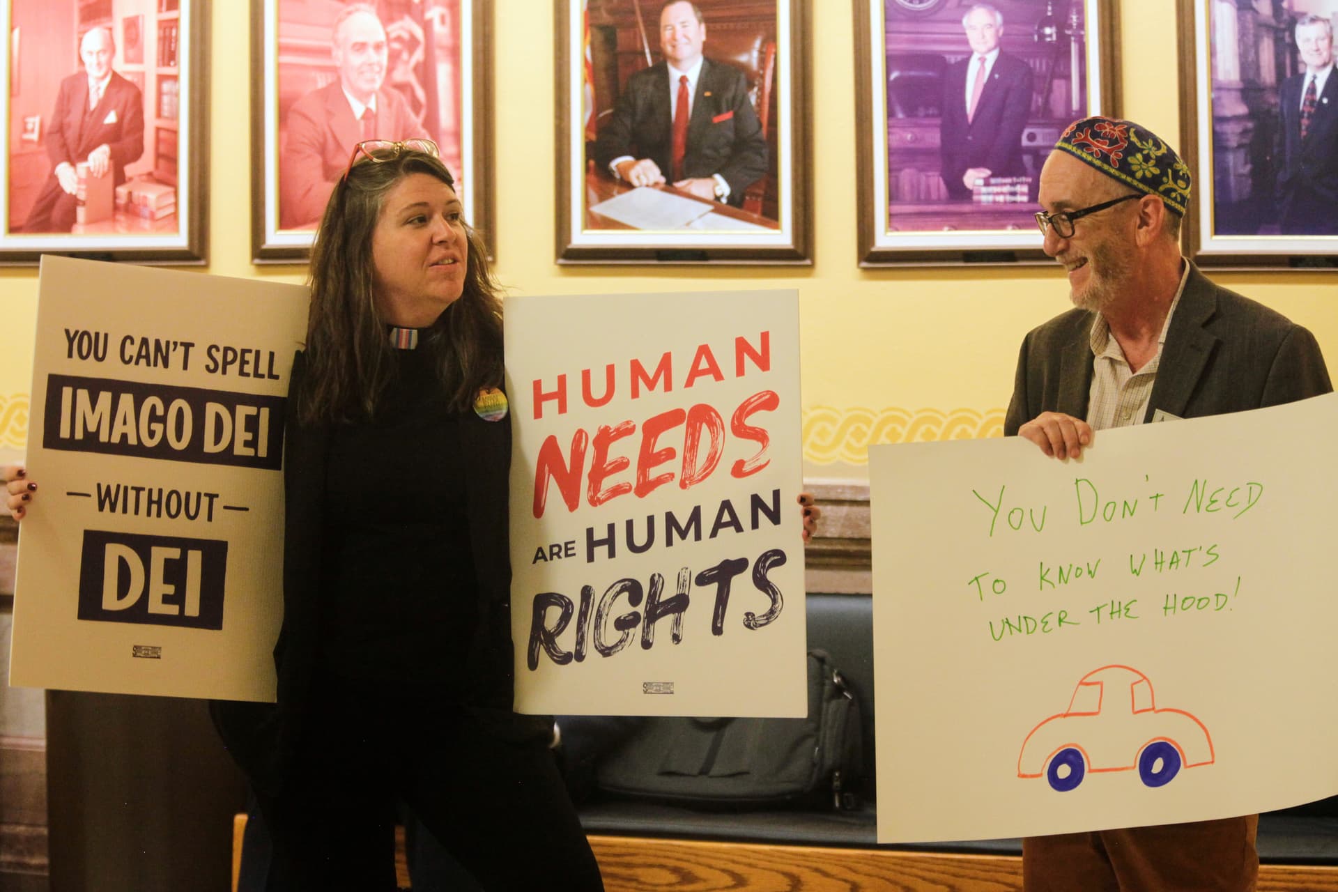 The Reverend Mandy Todd, left, pastor of Messiah Lutheran Church in Lindsborg, Kansas, and Rabbi Moti Rieber, right, executive director of Kansas Interfaith Action, protest a new Kansas law that will invalidate hundreds of driver's licenses and birth certificates for transgender people that reflect their gender identities.