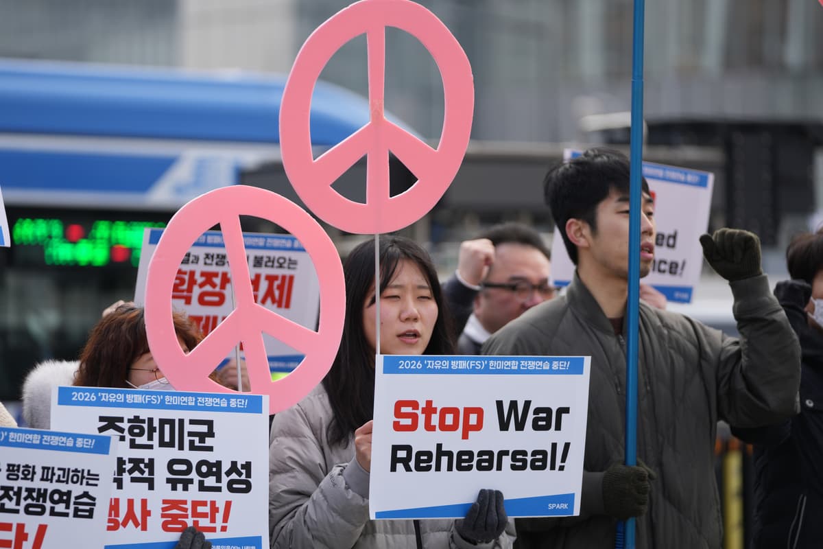 Protesters hold signs to oppose the joint military exercise between America and South Korea, near the U.S. Embassy in Seoul, South Korea, March 9, 2026.