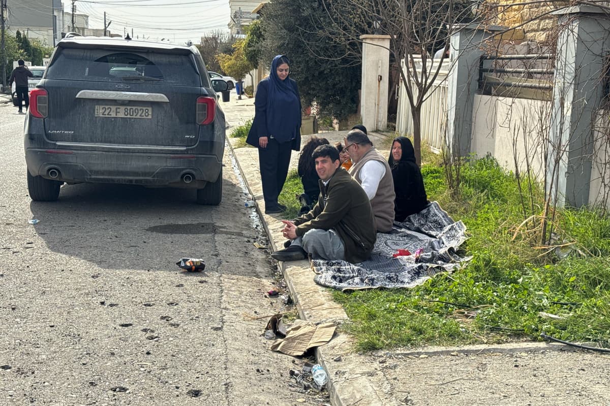 Kurds sit outside their homes, damaged following a drone attack that struck their neighbourhood in Irbil, Iraq, March 4, 2026. 