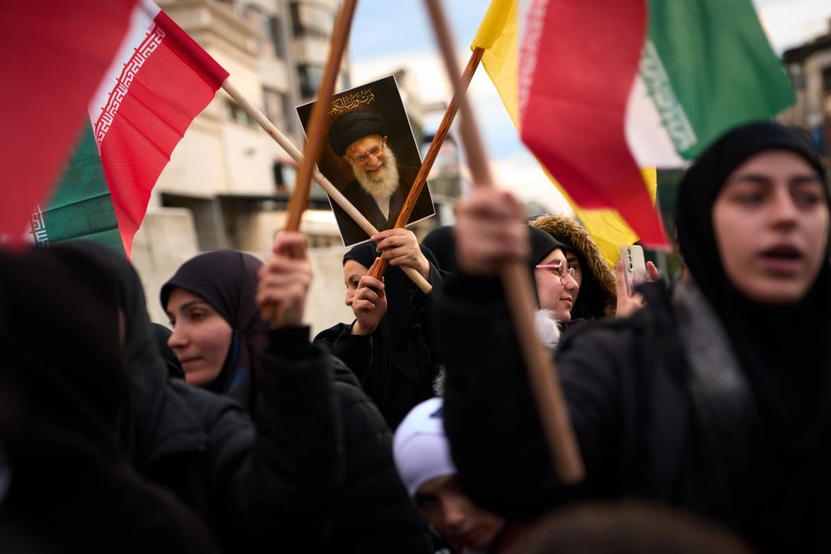 A woman holds a portrait of Iran's late Supreme Leader during a protest outside Iran's embassy at Beirut.