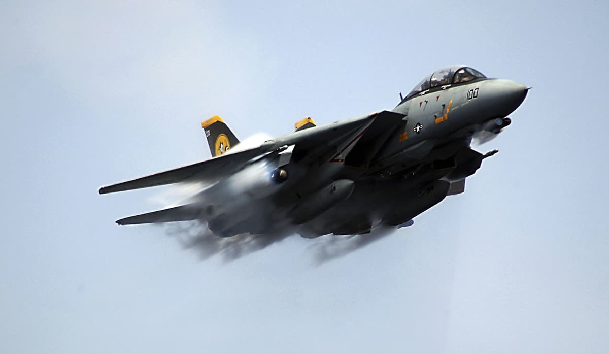 An F-14D Tomcat assigned to the 'Tomcatters' of Fighter Squadron Three One (VF-31), makes a near supersonic fly-by above the flightdeck of the USS Theodore Roosevelt on July 28, 2006 at Sea.