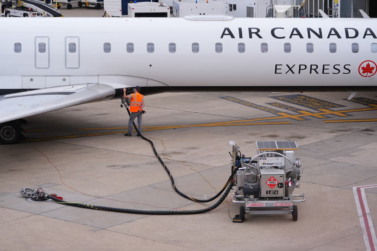 A worker fuels an Air Canada jet at Dallas-Fort Worth International Airport at Grapevine, Texas, on April 14, 2026.