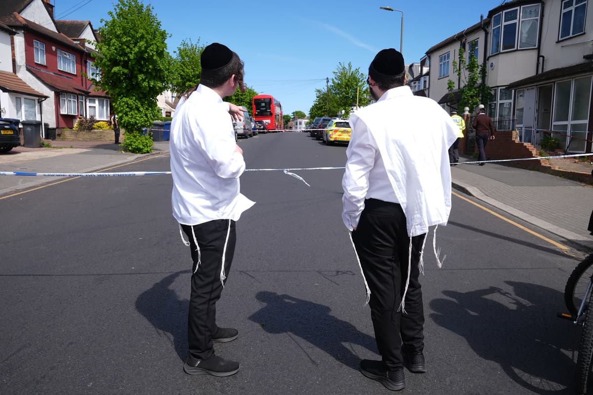 Members of the Jewish community stand at the scene where two people were stabbed, at Golders Green, April 29, 2026.