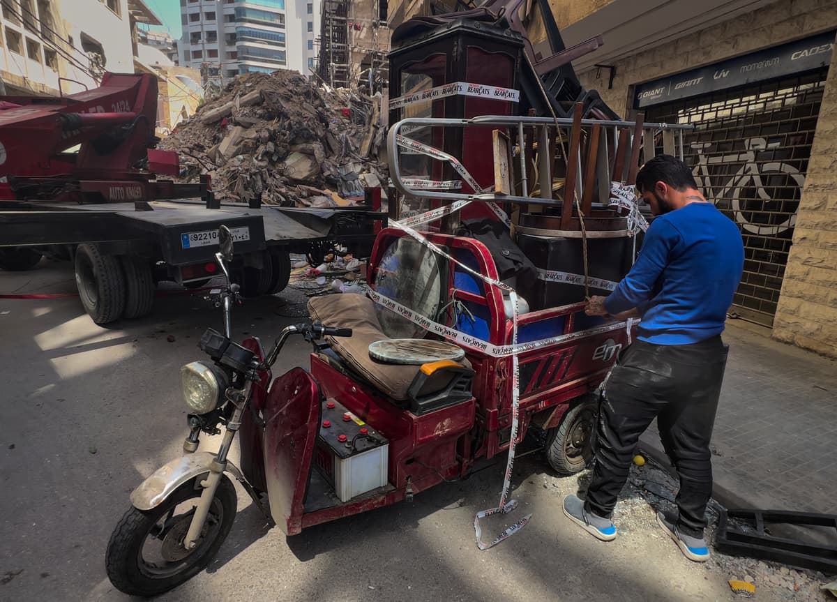 A worker arranges furniture from an apartment of a destroyed building that was hit a week ago in an Israeli airstrike at central Beirut, Lebanon on April 16, 2026.