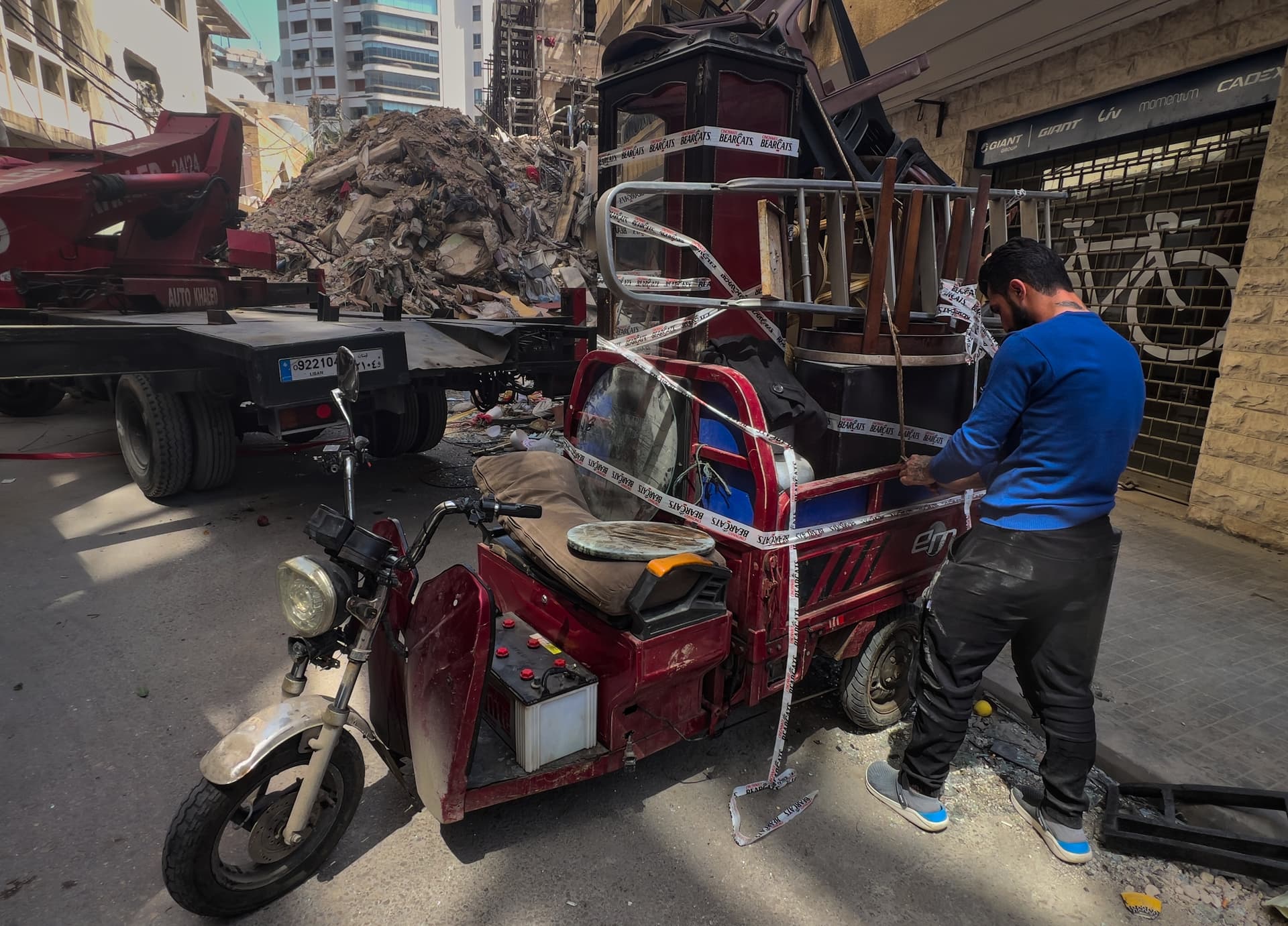 A worker arranges furniture from an apartment of a destroyed building that was hit a week ago in an Israeli airstrike at central Beirut, Lebanon on April 16, 2026.