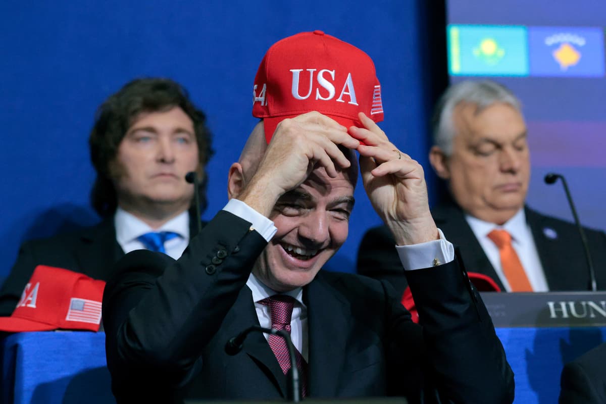 The FIFA president, Gianni Infantino, holds up a USA hat as he attends the inaugural meeting of the Board of Peace at Washington, D.C., on February 19, 2026.