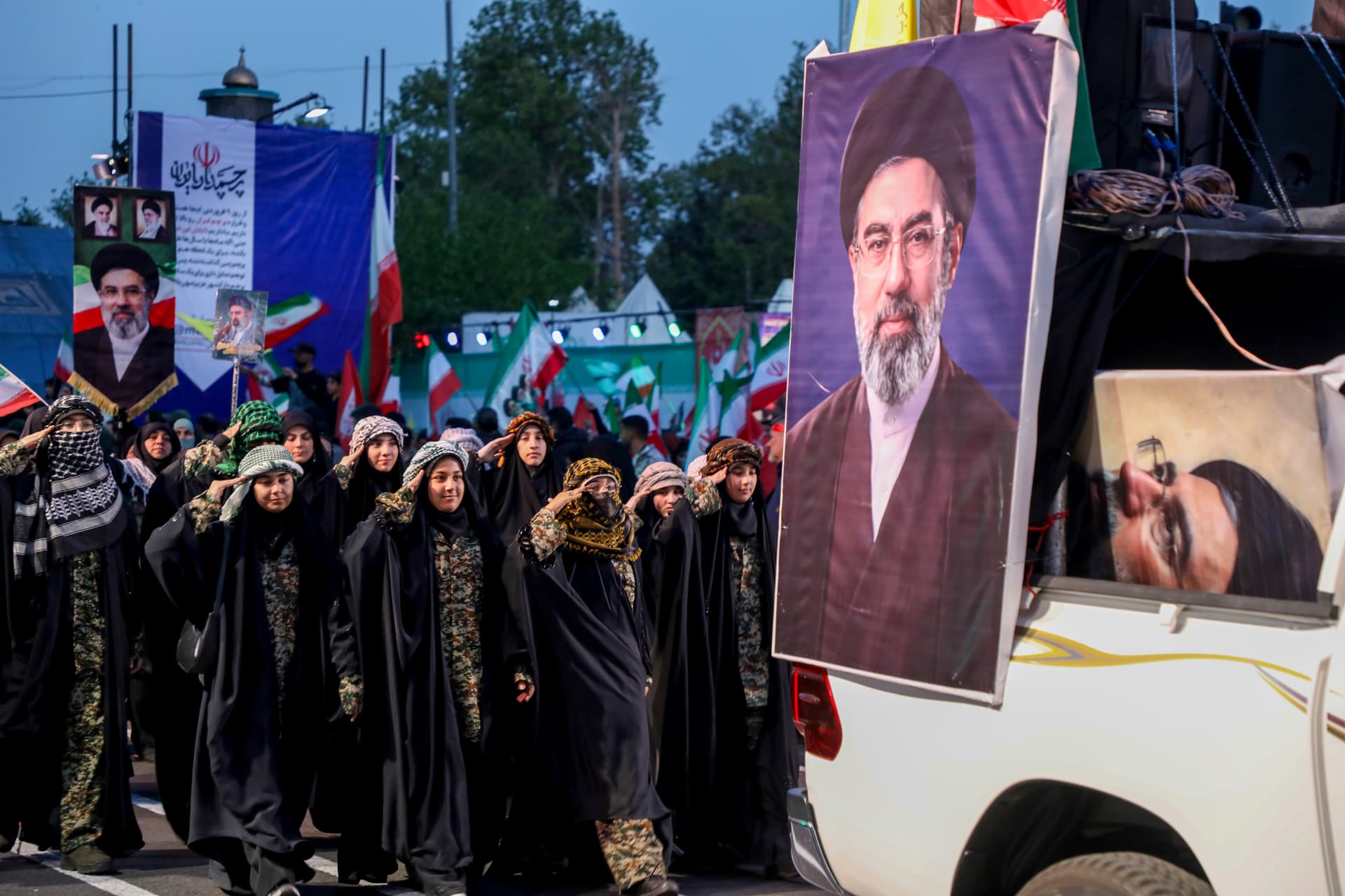 Portraits of Iran's supreme leader Ayatollah Mojtaba Khamenei are seen as women salute during a pro-government National Army Day demonstration on April 17, 2026 in Tehran, Iran. 