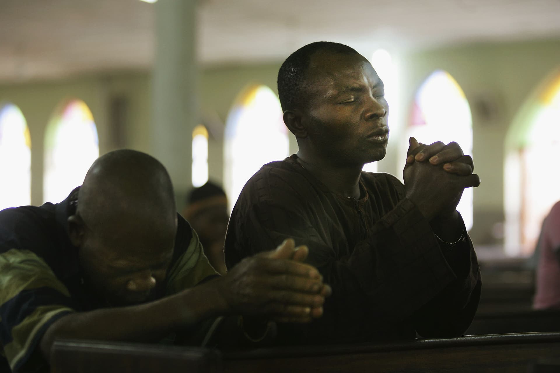 FILE: Nigerian Catholic worshippers pray during morning mass at Kano, Nigeria. 
