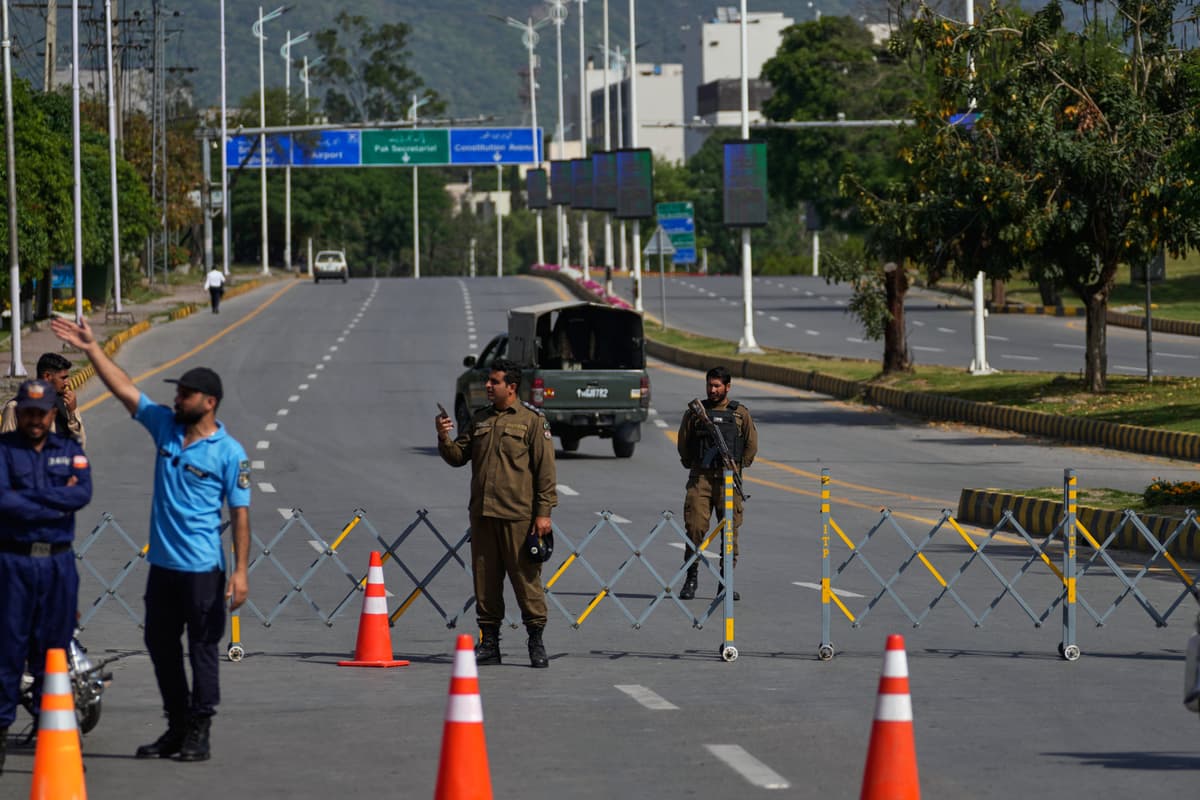 Police officers stand guard at a security checkpoint ahead of a scheduled second round of negotiations between America and Iran at Islamabad, Pakistan, on April 21, 2026.