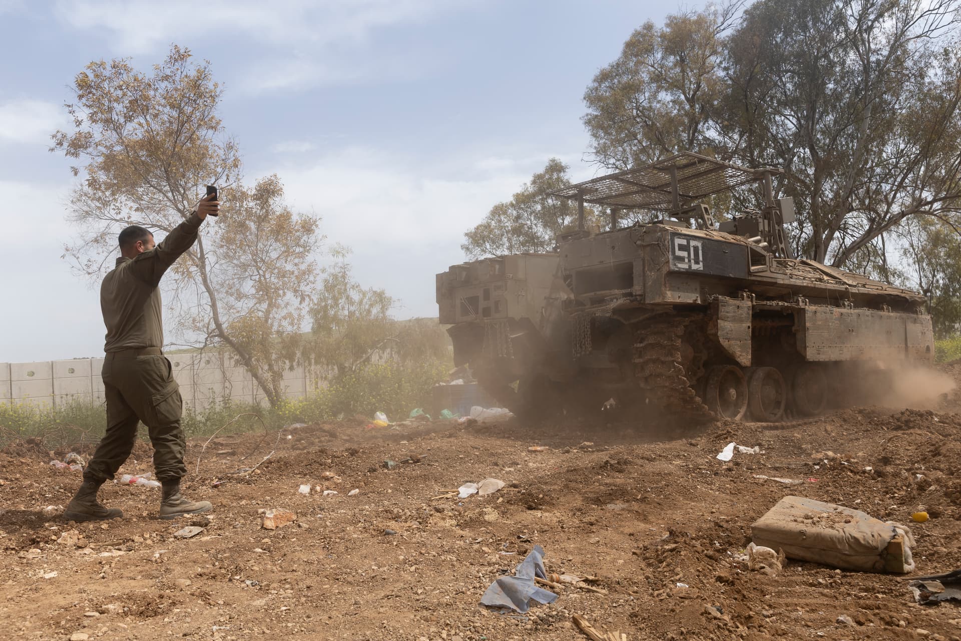 An Israeli soldier directs an armored personnel carrier near the border with Lebanon on April 17, 2026.
