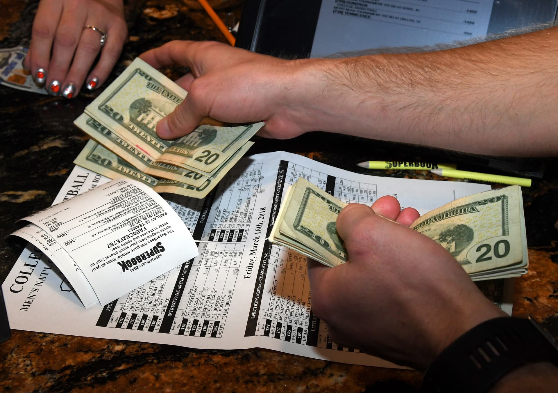A man places bets during a viewing party for the NCAA Men's College Basketball Tournament at a casino at Las Vegas on March 15, 2018.