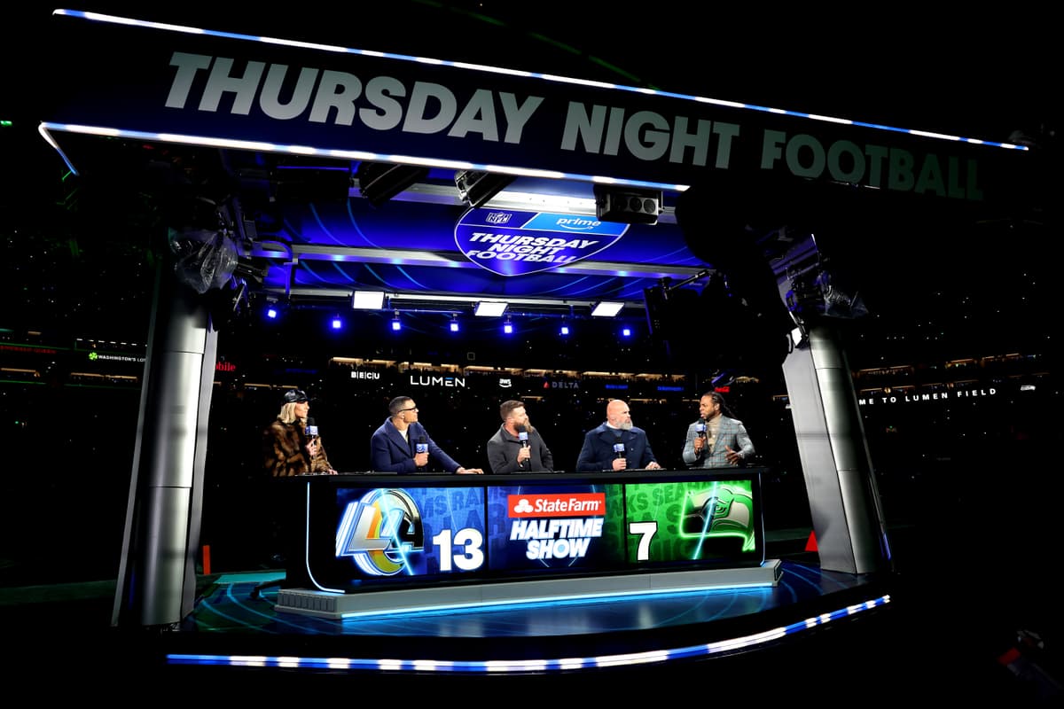 The cast of Thursday Night Football is seen during halftime of a game between the Los Angeles Rams and the Seattle Seahawks  at Seattle on December 18, 2025.
