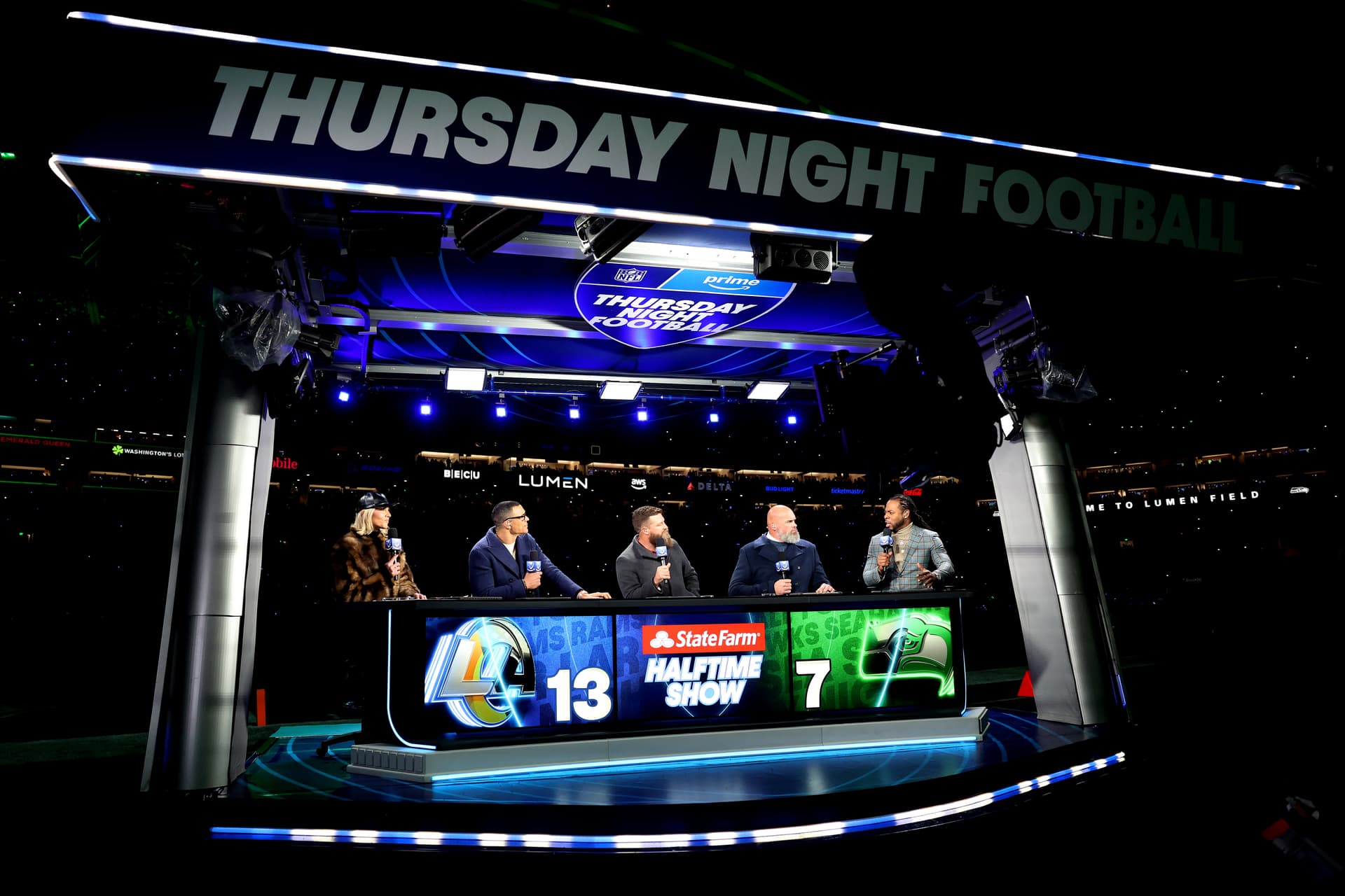 The cast of Thursday Night Football is seen during halftime of a game between the Los Angeles Rams and the Seattle Seahawks  at Seattle on December 18, 2025.