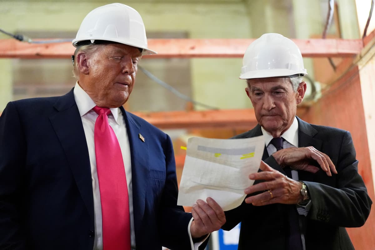 The Federal Reserve chairman, Jerome Powell, and President Trump look over a document of cost figures during a visit to the Federal Reserve on July 24, 2025.