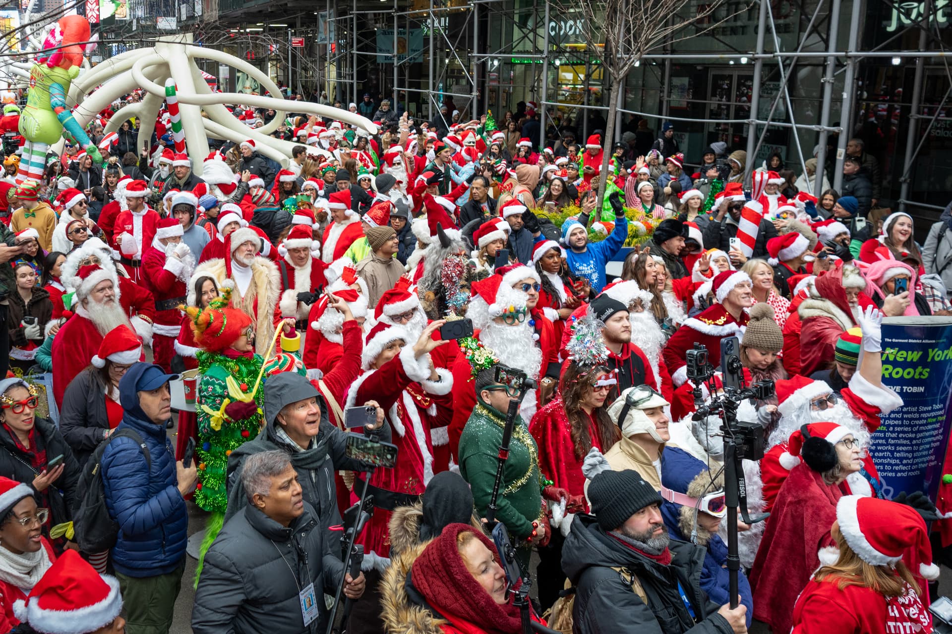 Revelers in holiday character costumes take part in the SantaCon bar crawl on December 13, 2025, at New York City.