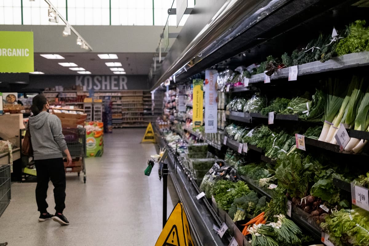 Customers shop for groceries at a supermarket at North Bethesda, Maryland, on April 12, 2022.