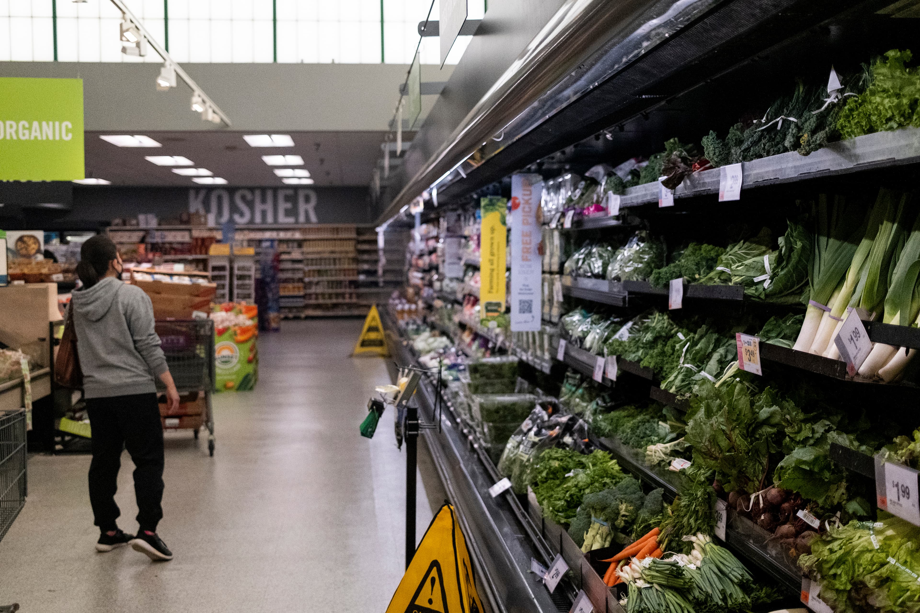 Customers shop for groceries at a supermarket at North Bethesda, Maryland, on April 12, 2022.