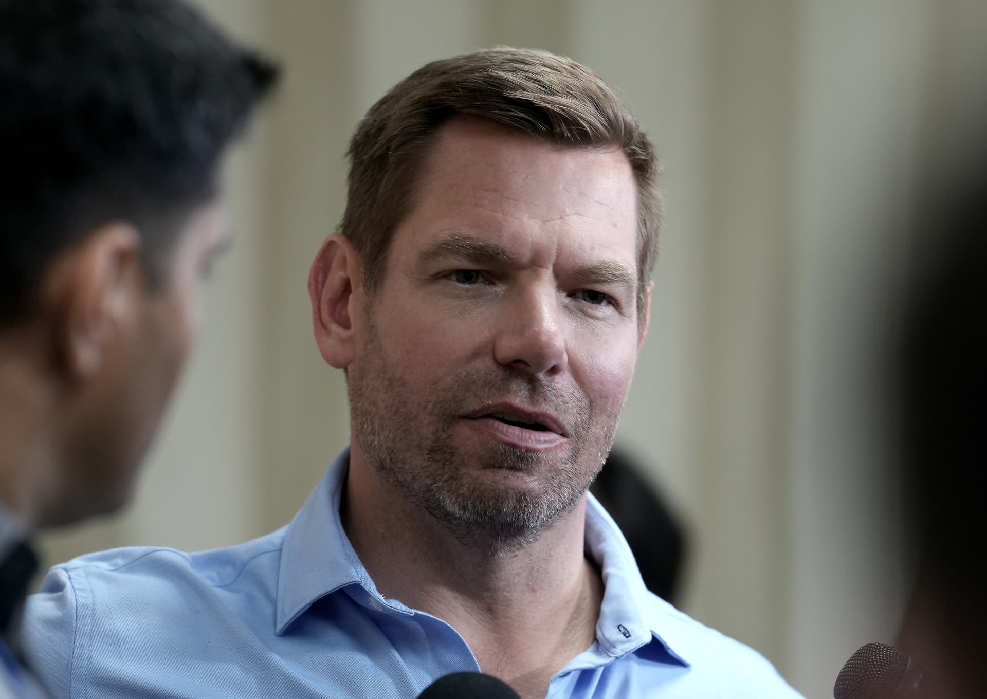 Representative Eric Swalwell talks with reporters after holding a town hall meeting at Sacramento, California, on April 7, 2026.