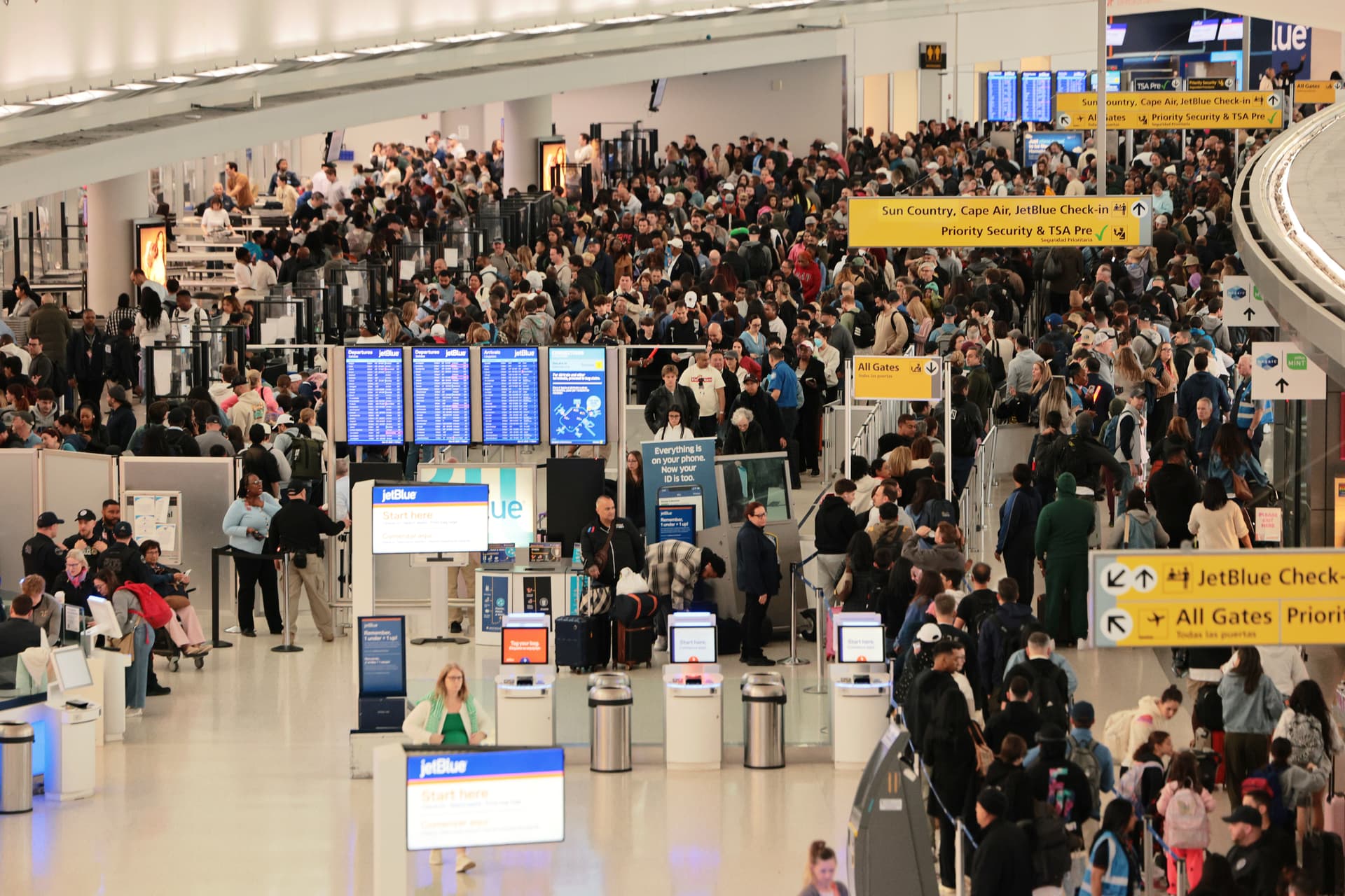 Travelers wait in line to go through security in Terminal 5 at John F. Kennedy International Airport on March 27, 2026.