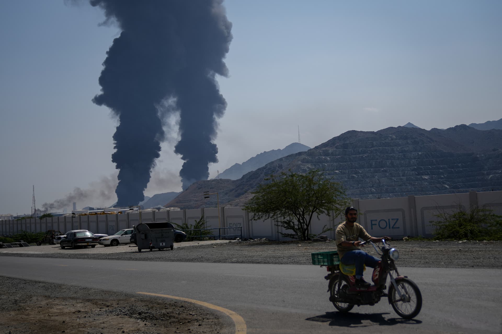 Plumes of smoke rise after debris from an intercepted Iranian drone struck an oil facility at Fujairah, United Arab Emirates, on March 14, 2026.
