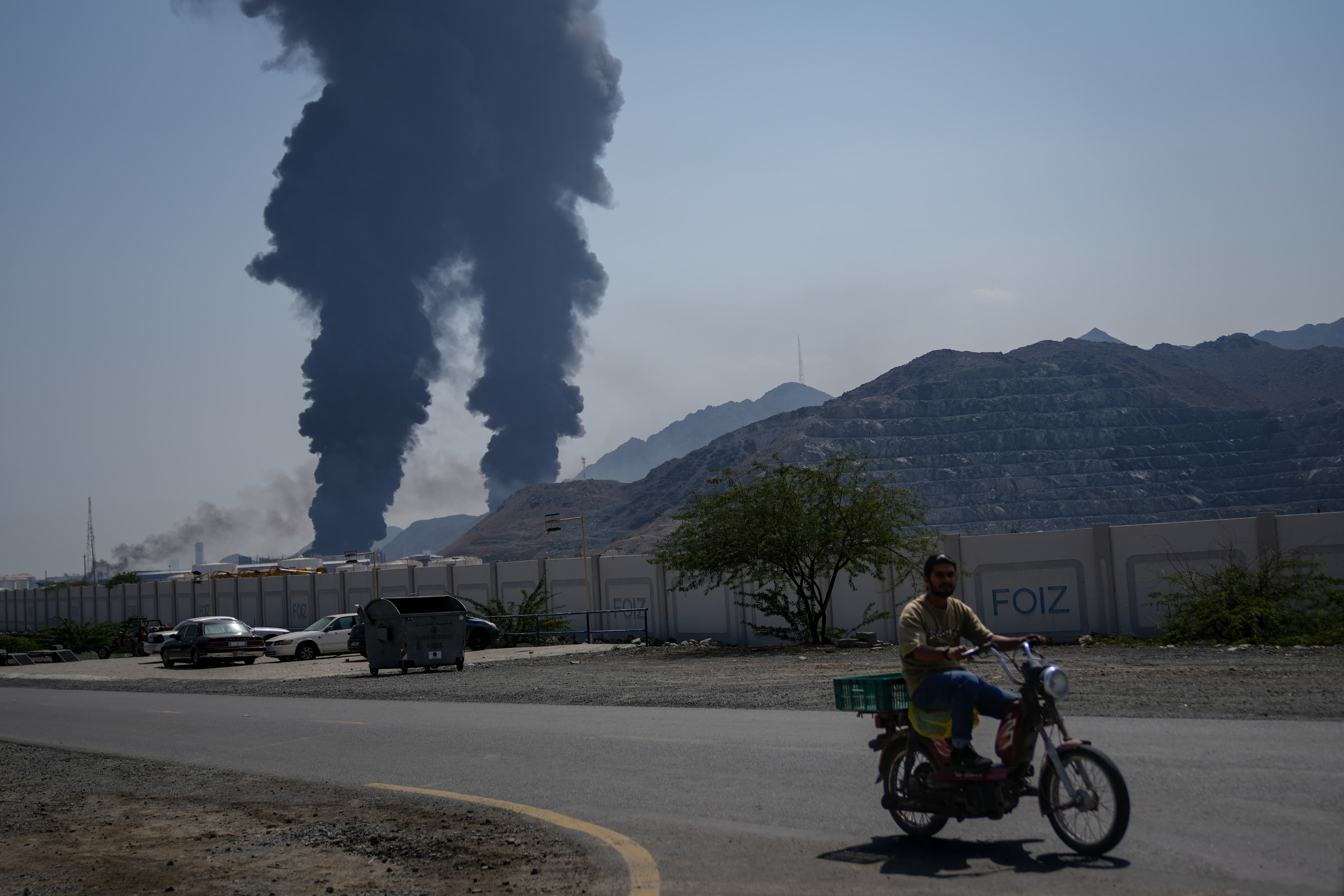 Plumes of smoke rise after debris from an intercepted Iranian drone struck an oil facility at Fujairah, United Arab Emirates, on March 14, 2026.