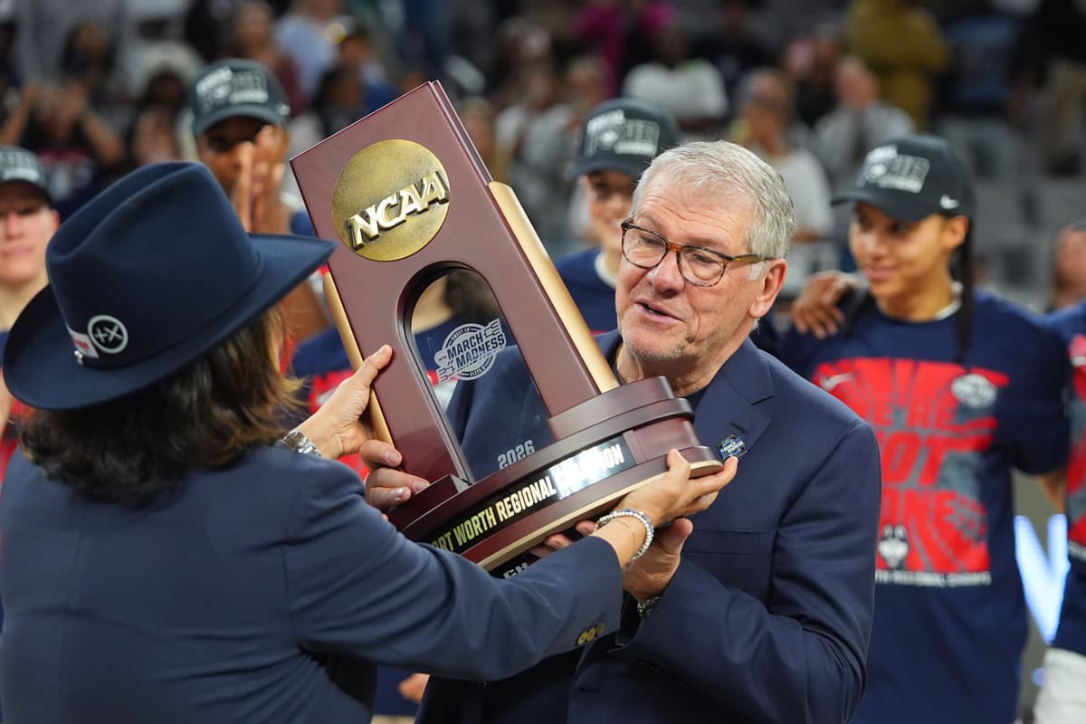 UConn’s women’s head coach, Geno Auriemma, is presented with a regional championship trophy after his team defeated Notre Dame to advance to the Final Four at Fort Worth, Texas, on March 29, 2026.