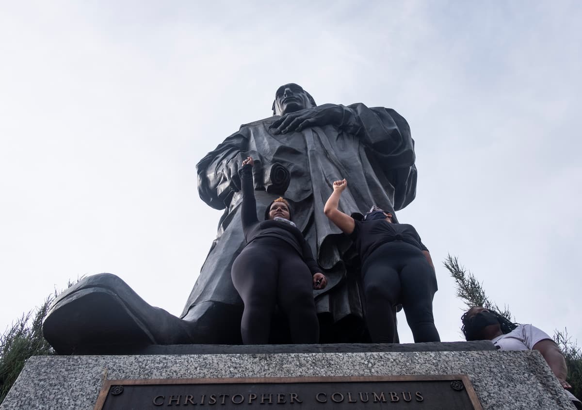 Protesters at the base of the Christopher Columbus Statue at Columbus City Hall during a protest on June 27, 2020.
